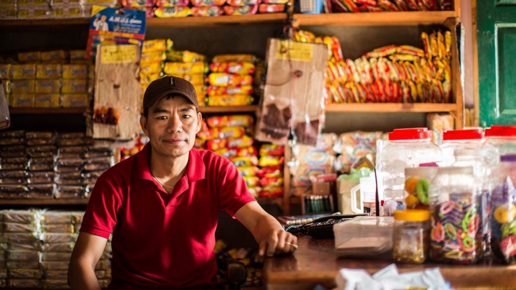 Shopkeeper behind the counter of a retail shop