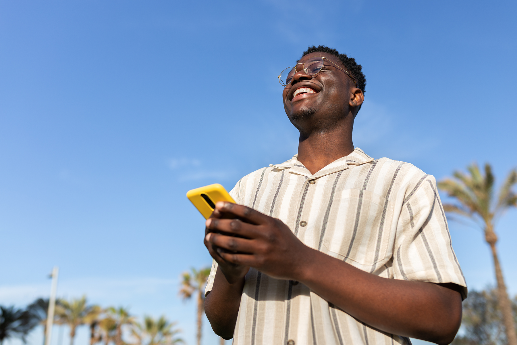 Man topping up phone credit outdoors