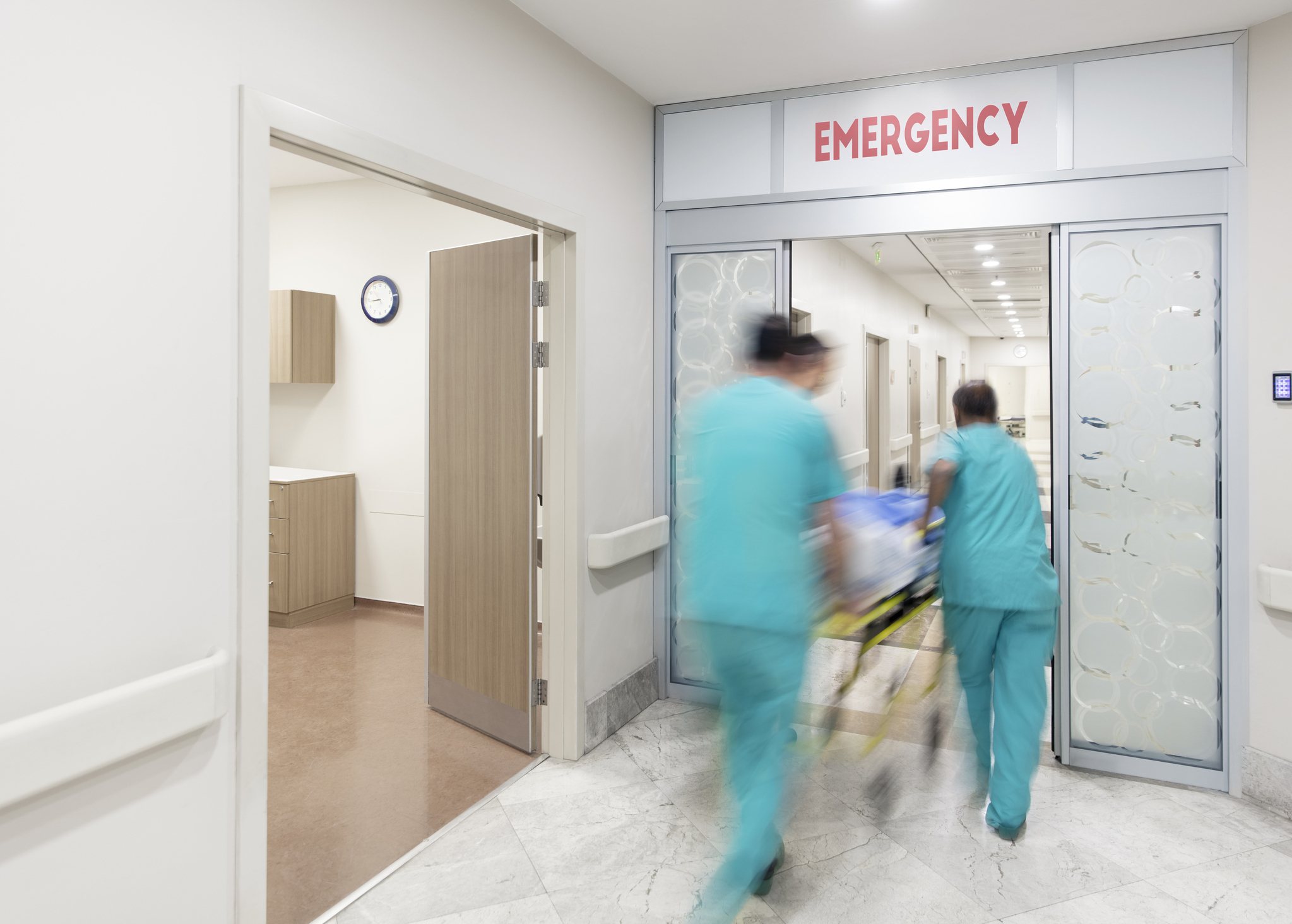 Medical staff moving through a hospital emergency entrance