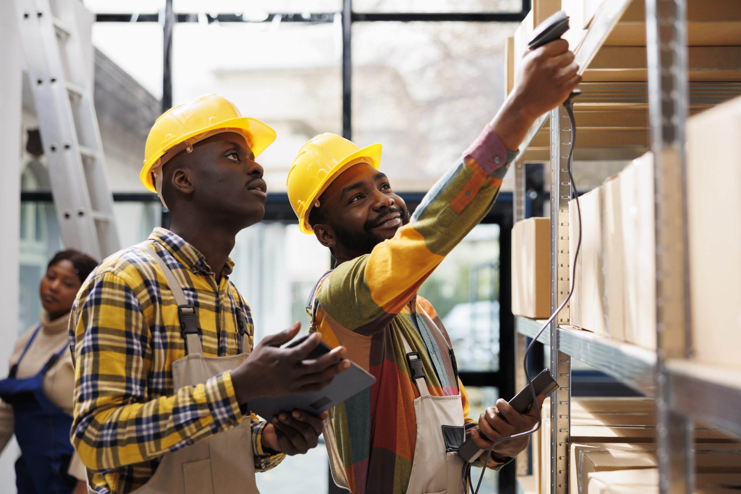 Warehouse workers checking stock on shelving